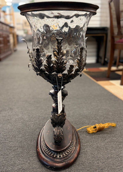 A decorative table lamp constructed from iron, ceramic, and glass in excellent condition.