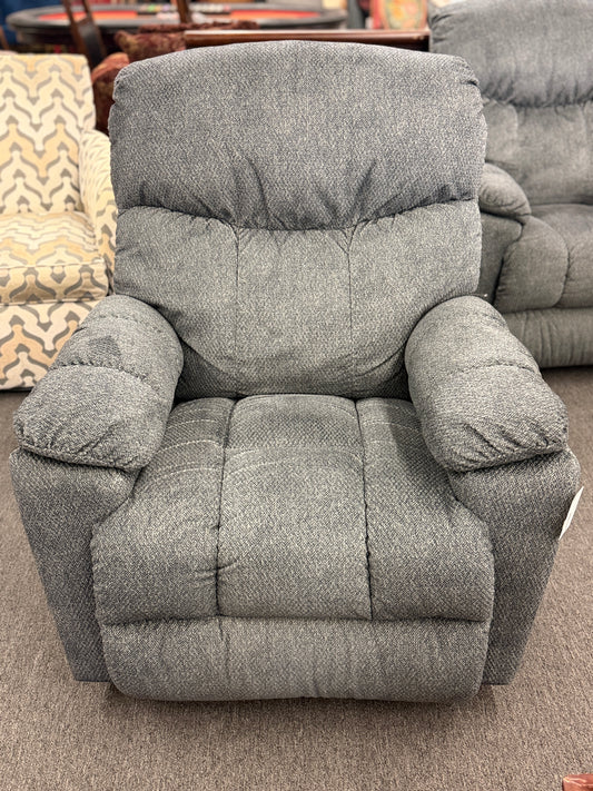 A plush fabric and wood La-Z-Boy reclining armchair in excellent condition.