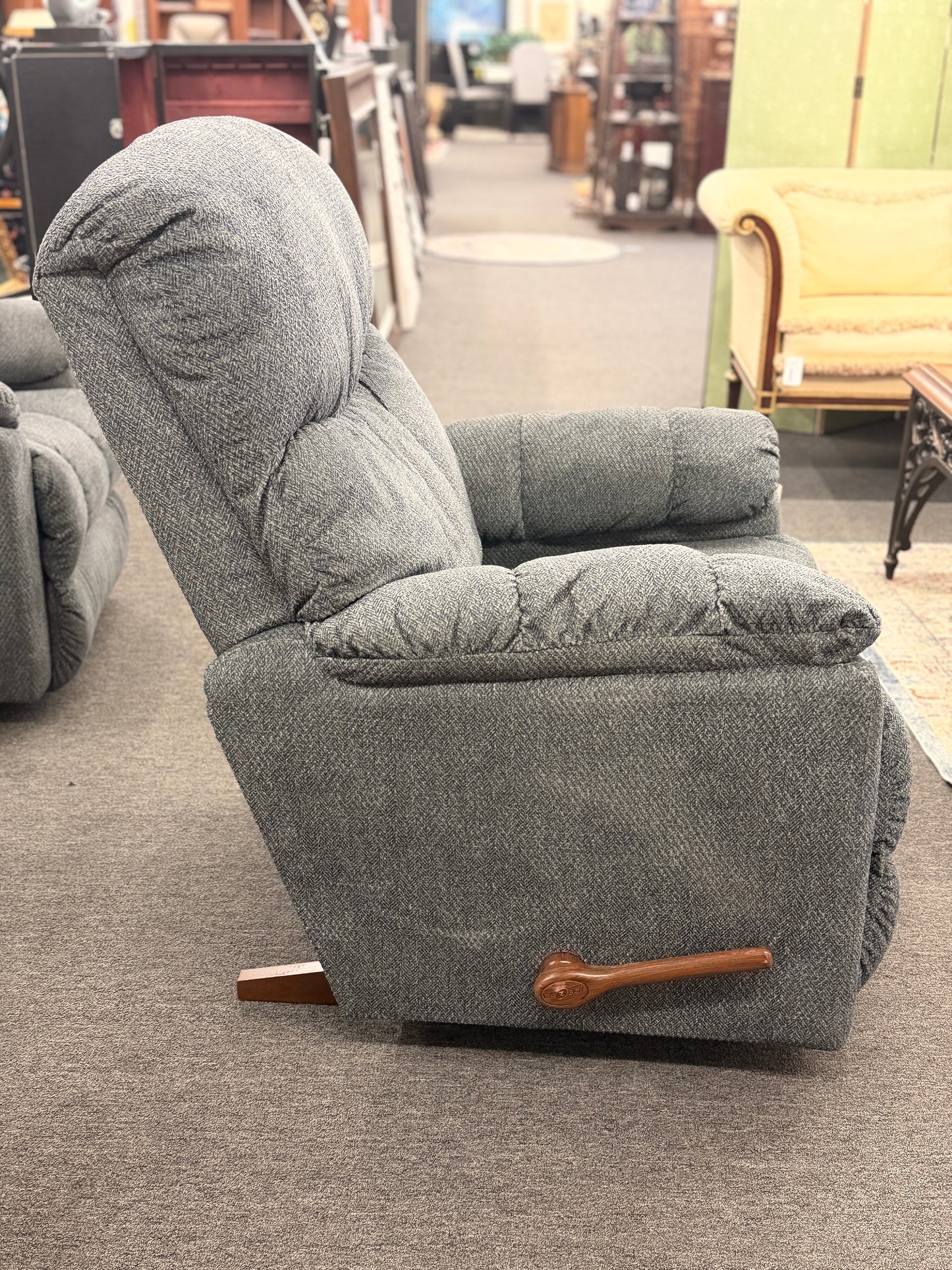A plush fabric and wood La-Z-Boy reclining armchair in excellent condition.