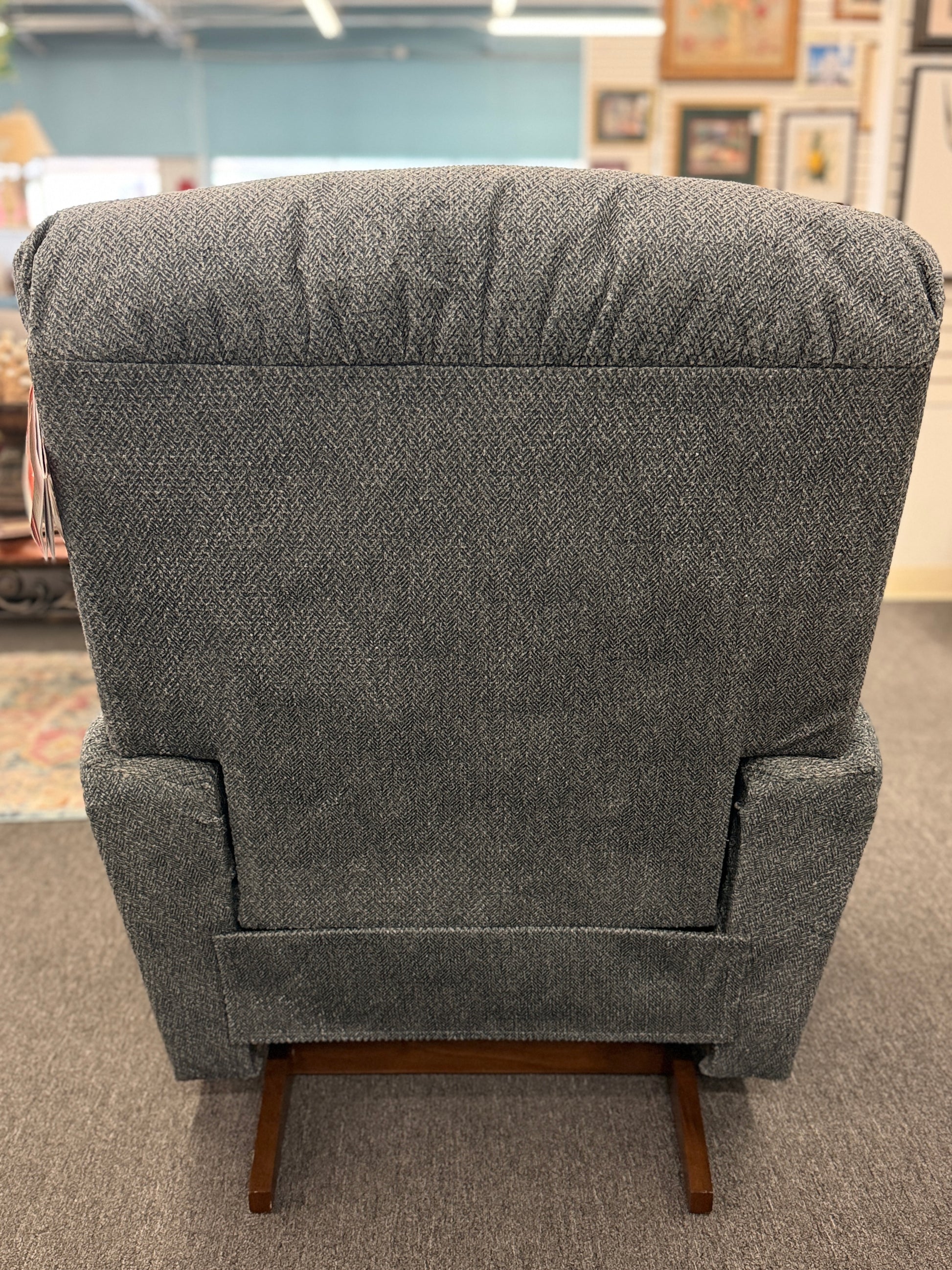 A plush fabric and wood La-Z-Boy reclining armchair in excellent condition.