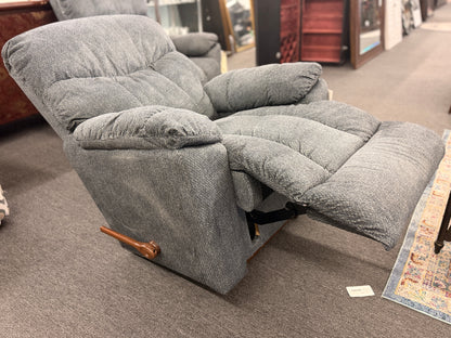 A plush fabric and wood La-Z-Boy reclining armchair in excellent condition.