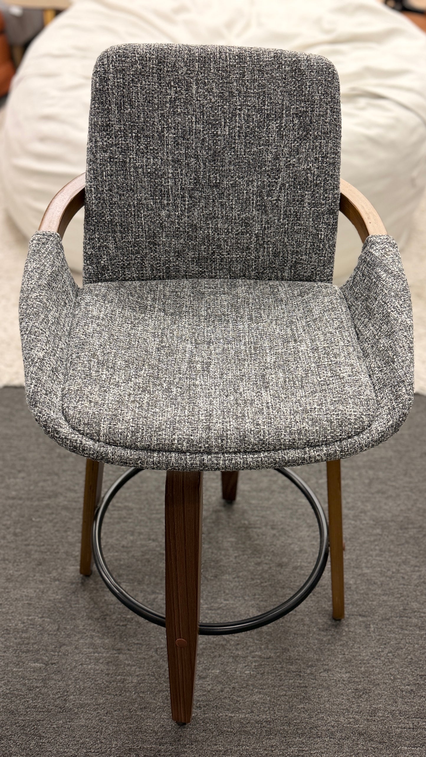 A 3-piece set of mid-century modern barstools featuring textured gray tweed upholstered seats, curved walnut wood armrests, and tapered legs with a black metal footrest ring.