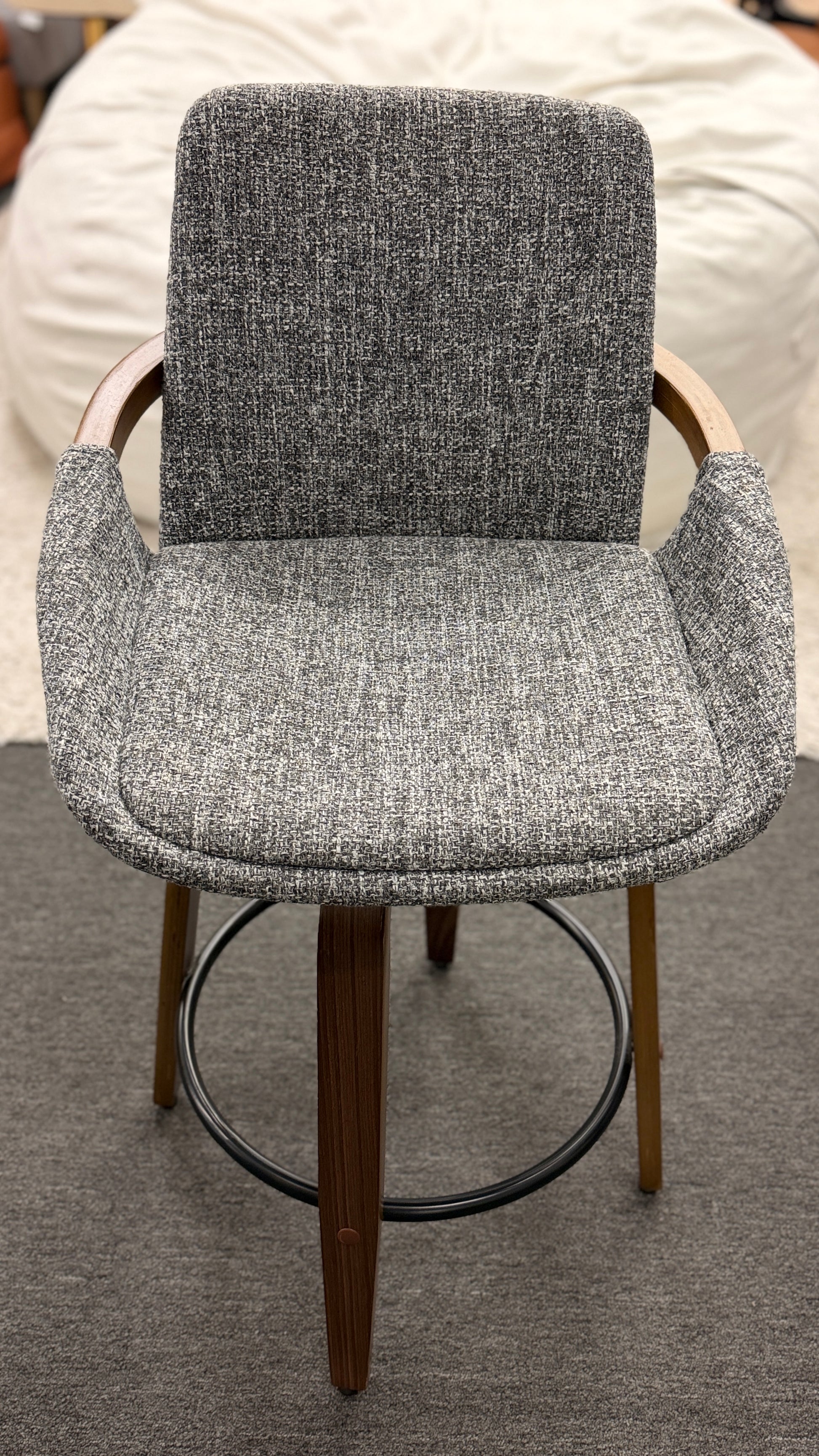 A 3-piece set of mid-century modern barstools featuring textured gray tweed upholstered seats, curved walnut wood armrests, and tapered legs with a black metal footrest ring.