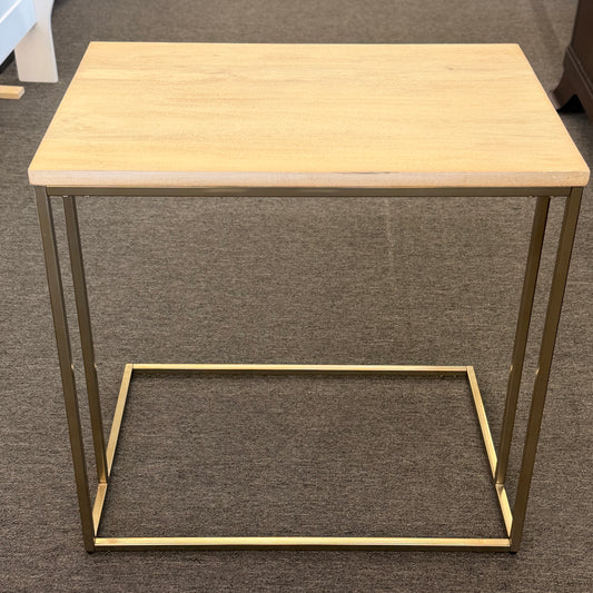 A minimalist C-shaped end table with a wooden tabletop and a slender black metal frame designed to slide over a sofa arm.