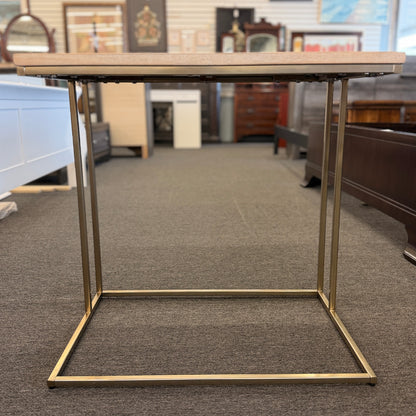 A minimalist C-shaped end table with a wooden tabletop and a slender black metal frame designed to slide over a sofa arm.