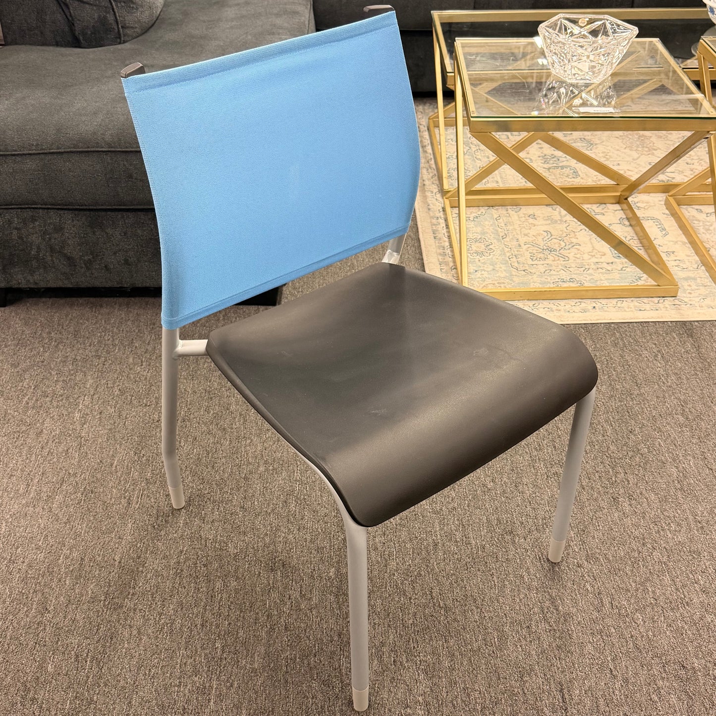 Modern lightweight synthetic and metal office desk chair featuring a blue backrest and a brown seat in a living room setting at 2nd Debut Houston consignment showroom