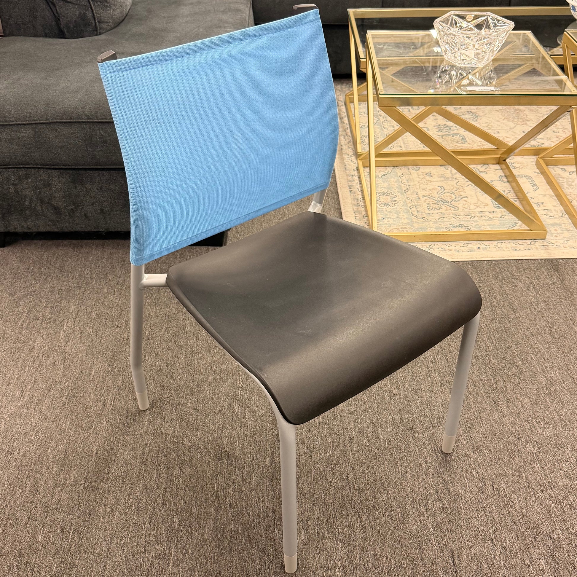 Modern lightweight synthetic and metal office desk chair featuring a blue backrest and a brown seat in a living room setting at 2nd Debut Houston consignment showroom