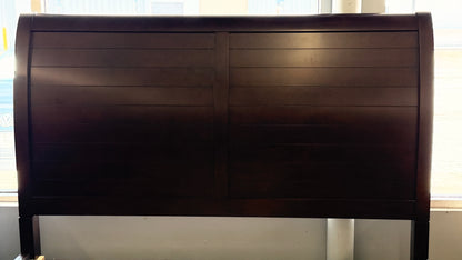 A modern dark-wood queen platform bed frame with a horizontal-paneled headboard, six footboard storage drawers, and matching three-drawer nightstands.