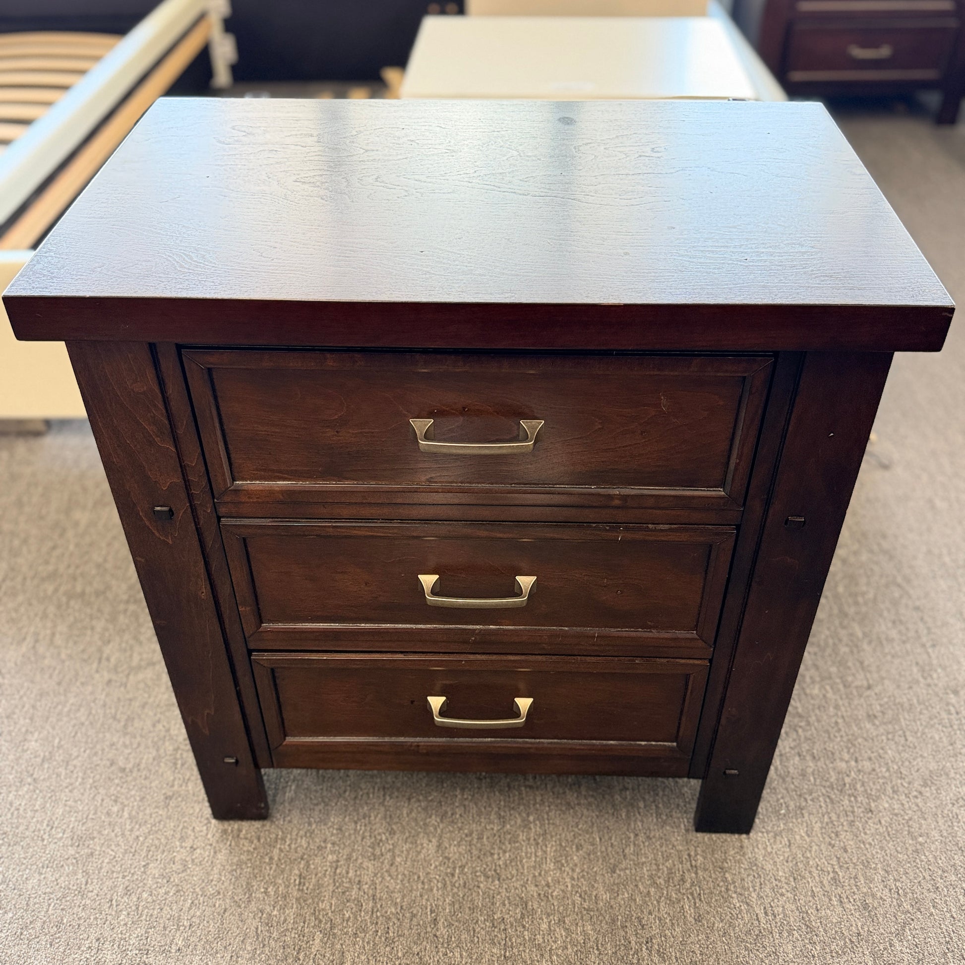 A modern dark-wood queen platform bed frame with a horizontal-paneled headboard, six footboard storage drawers, and matching three-drawer nightstands.