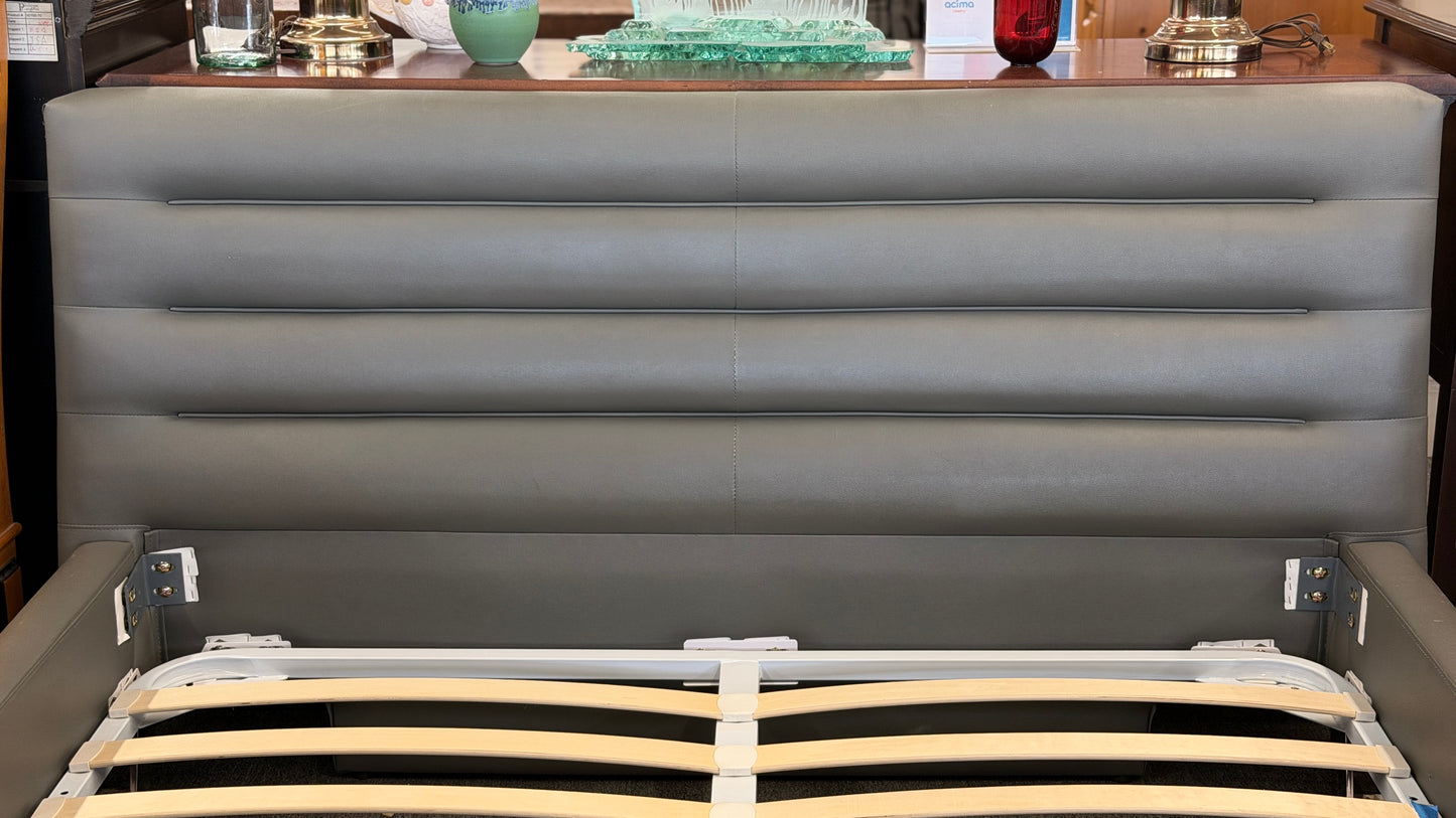 Modern gray upholstered queen platform bed featuring a horizontal channel tufted headboard and wooden slat mattress support without a box spring.