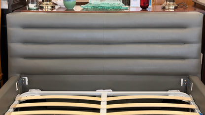 Modern gray upholstered queen platform bed featuring a horizontal channel tufted headboard and wooden slat mattress support without a box spring.