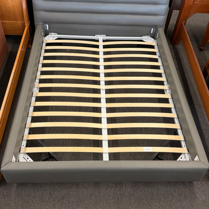 Modern gray upholstered queen platform bed featuring a horizontal channel tufted headboard and wooden slat mattress support without a box spring.