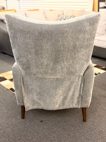 A sleek push-back recliner chair upholstered in heather-gray textured fabric featuring track arms, subtle vertical tufting, and tapered dark wood legs in excellent condition.