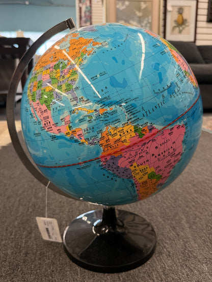 A modern world globe mounted on a brushed metal semi-meridian arc with a glossy black circular pedestal base in excellent condition.