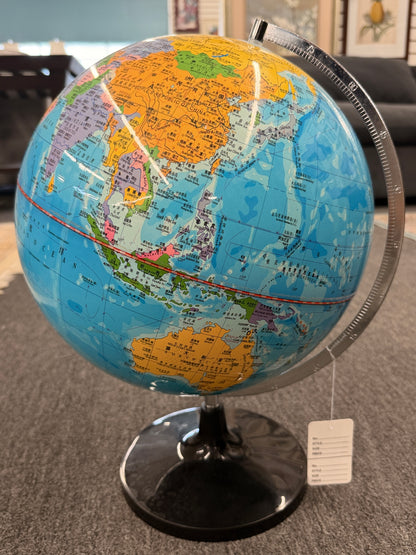 A modern world globe mounted on a brushed metal semi-meridian arc with a glossy black circular pedestal base in excellent condition.