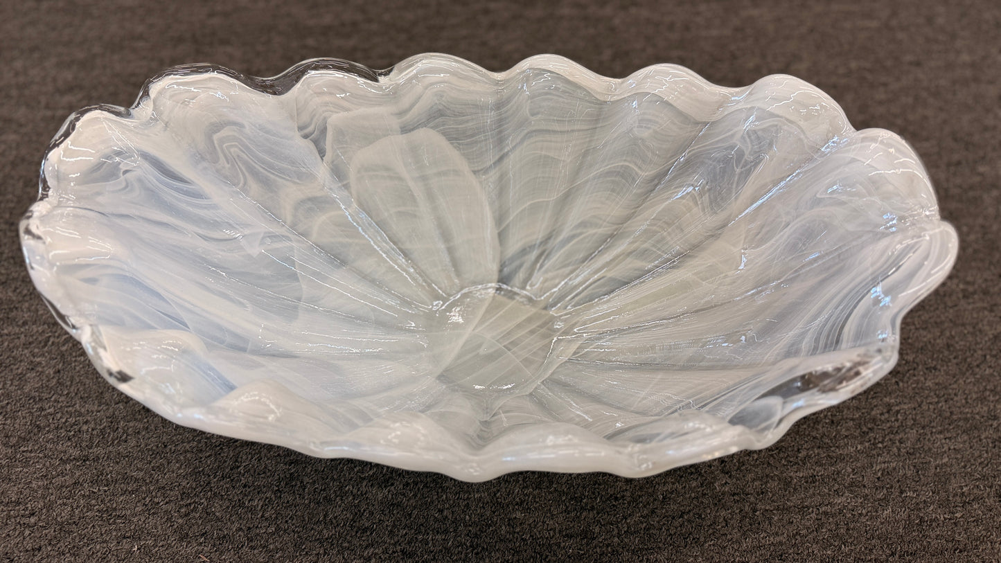 An elegant 20-inch wide decorative glass centerpiece bowl in an opalescent milky-white color, featuring a deeply ruffled and scalloped edge shaped like a sea shell.