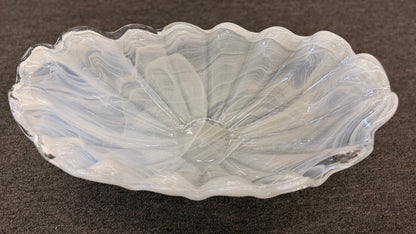 An elegant 20-inch wide decorative glass centerpiece bowl in an opalescent milky-white color, featuring a deeply ruffled and scalloped edge shaped like a sea shell.