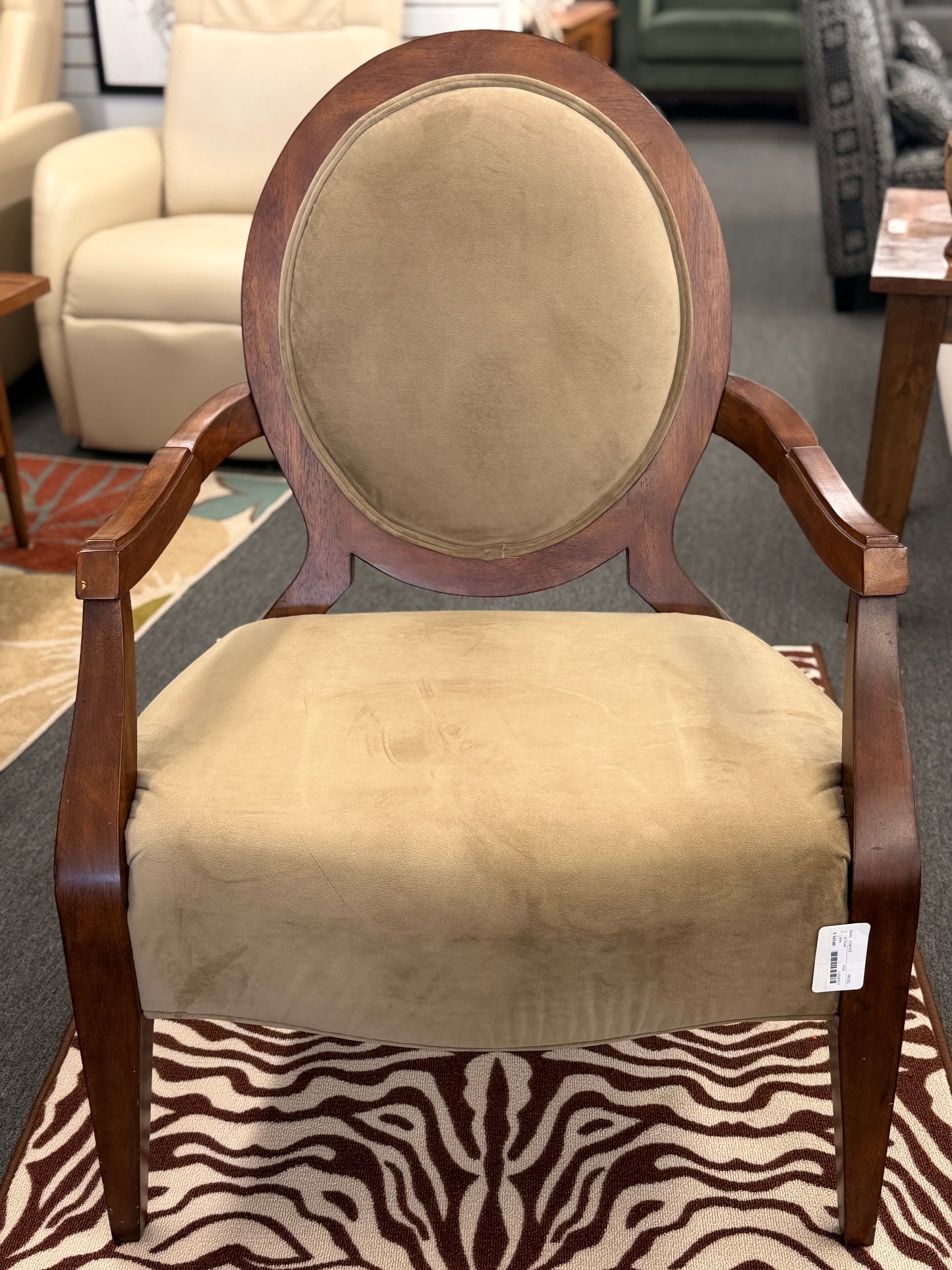Traditional oval back wood accent armchair in sage taupe velvet upholstery on a zebra print rug at 2nd Debut Houston consignment showroom