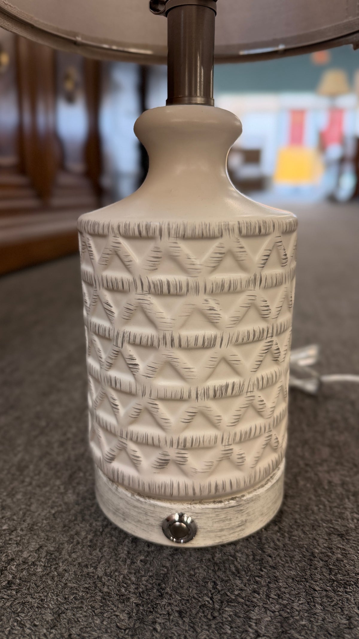 A pair of modern ceramic table lamps featuring textured geometric cream bases and neutral linen drum shades in excellent condition.