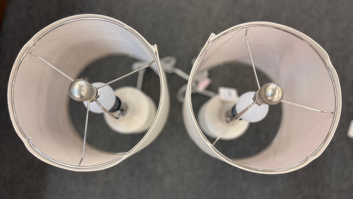A pair of modern ceramic table lamps featuring textured geometric cream bases and neutral linen drum shades in excellent condition.