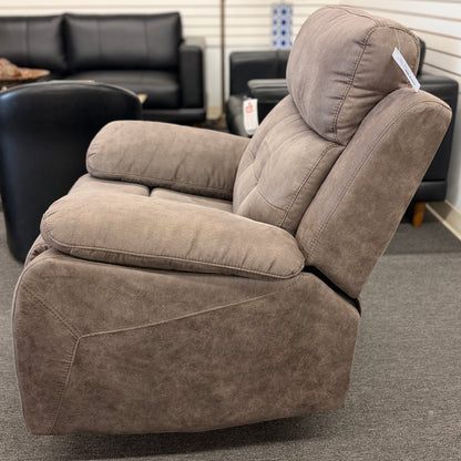 A plush, overstuffed recliner chair in a soft, medium-brown fabric with thickly padded pillow-top armrests and deep back cushioning.