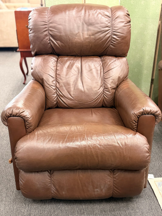 A plush, overstuffed brown leather recliner chair with thick pillowy back cushions and traditional rolled arms.