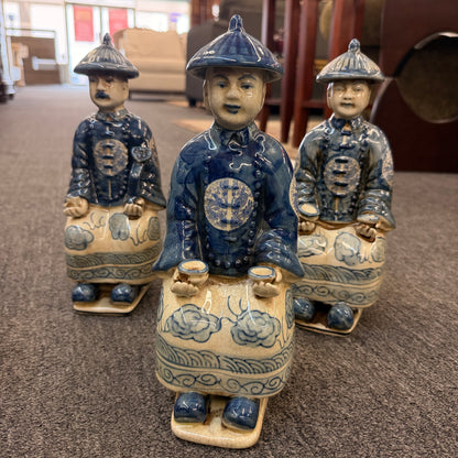 A set of six hand-painted blue and white porcelain figurines depicting seated Qing Dynasty scholars in traditional robes and mandarin hats in excellent condition.