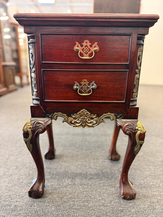 A Queen Anne-style two-drawer nightstand in rich mahogany featuring ornate brass hardware, cabriole legs, and ball-and-claw feet in good condition.