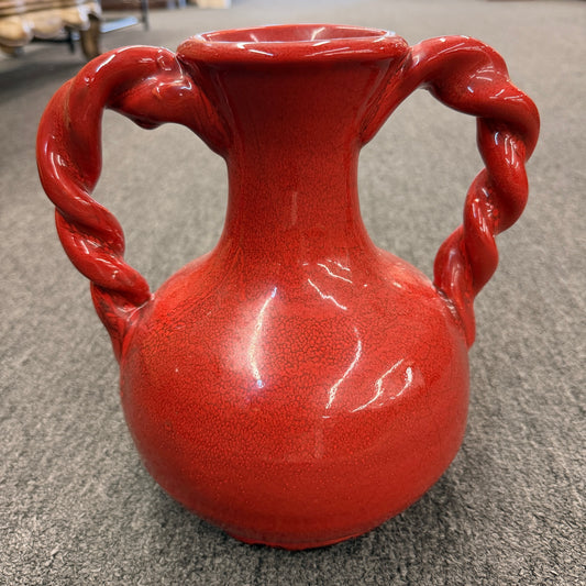 A red crackle-glazed ceramic urn vase featuring two twisted rope handles and a bulbous body in excellent condition.