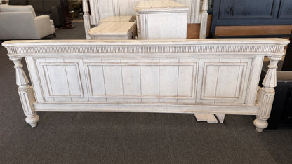 A 4-piece rustic cottage king bedroom set featuring an arched panel headboard bed frame, two nightstands, and a dresser in an antique whitewash finish.