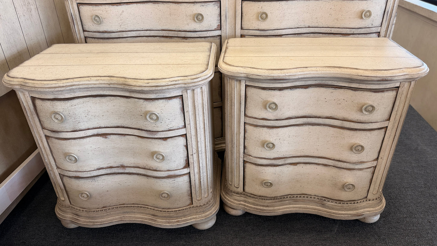 A 4-piece rustic cottage king bedroom set featuring an arched panel headboard bed frame, two nightstands, and a dresser in an antique whitewash finish.