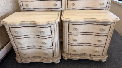 A 4-piece rustic cottage king bedroom set featuring an arched panel headboard bed frame, two nightstands, and a dresser in an antique whitewash finish.