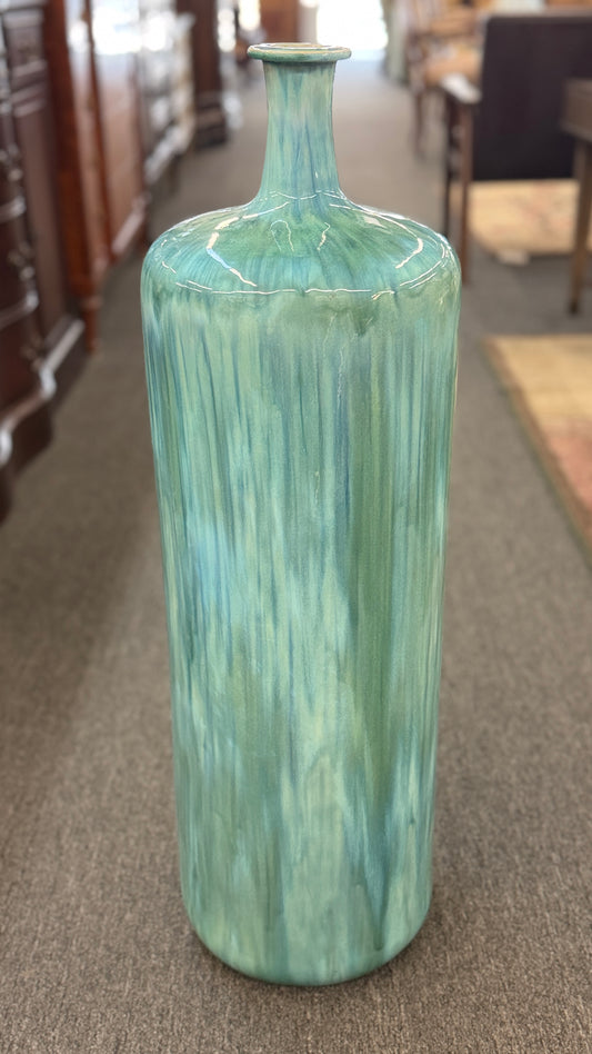 A tall, large cylindrical ceramic floor vase with a narrow neck, featuring a glossy, vertically streaked drip-glaze finish in seafoam green, aqua, and pale blue.