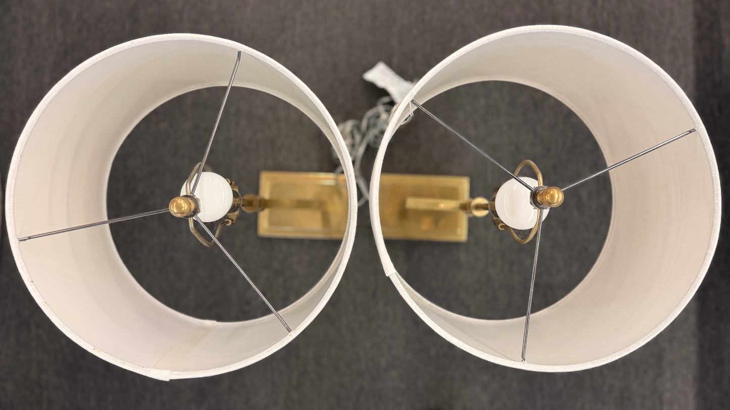 Matching pair of contemporary brass table lamps featuring stepped rectangular bases, angular geometric stems, and white fabric drum shades.