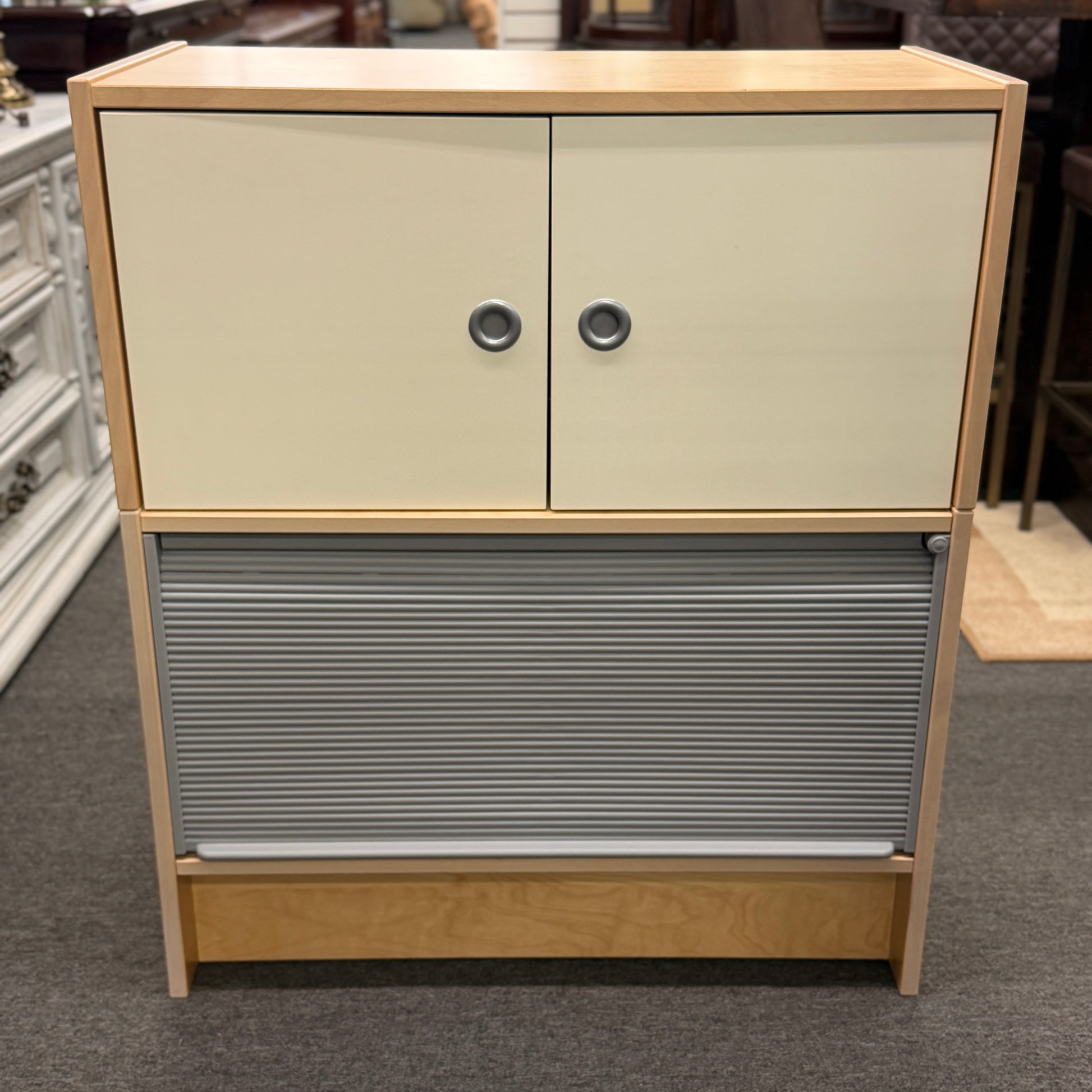 Contemporary dual tone mixed media file cabinet featuring beige doors and a silver metallic tambour roll top door on a carpeted floor at 2nd Debut Houston consignment showroom