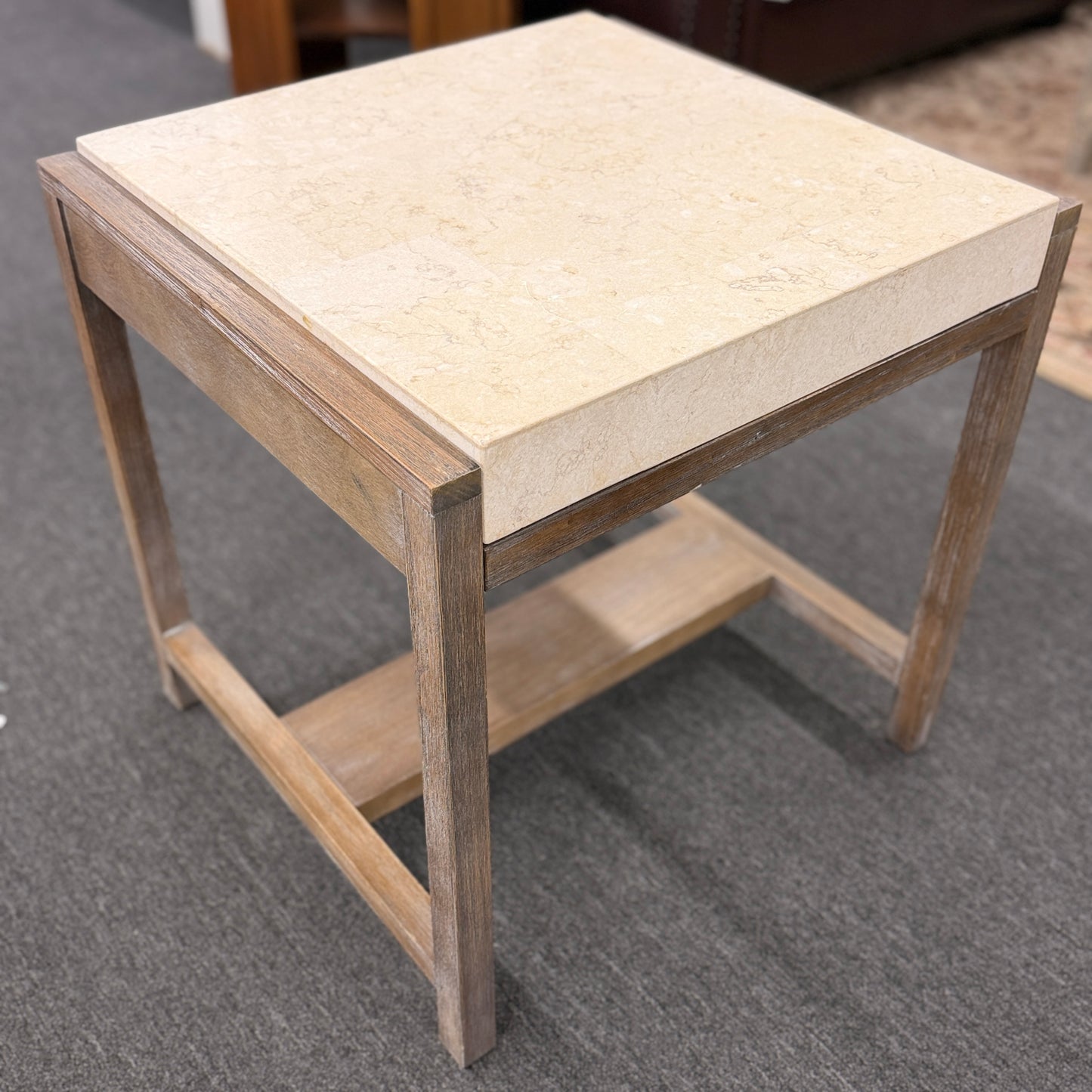Square end table featuring a thick light-colored stone top, distressed wood frame, and a lower crossbar shelf with rustic styling.