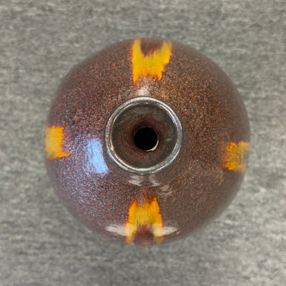 A tall teardrop-shaped ceramic vase featuring a textured mottled dark brown glaze with a vertical yellow and red-brown streak.