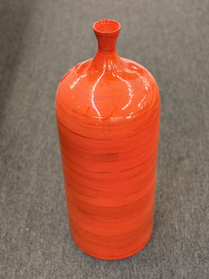 A tall slender ceramic floor vase with a narrow neck, vibrant glossy orange finish, and subtle horizontal ribbing in excellent condition.