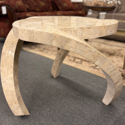 Tessellated stone end table featuring a polished light-colored stone mosaic, organic rounded triangular top, and sculptural curved three-leg base.