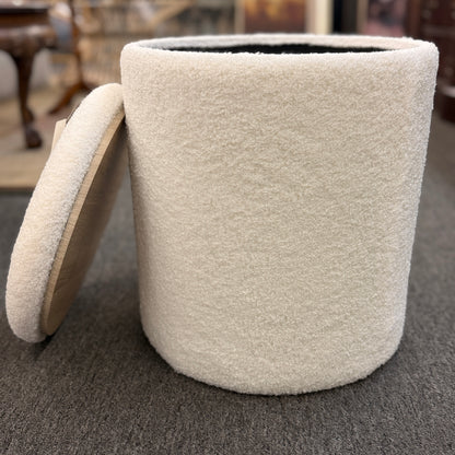 Round textured upholstered storage ottoman featuring a removable lid and hidden storage compartment, ideal as a footrest or extra seating.