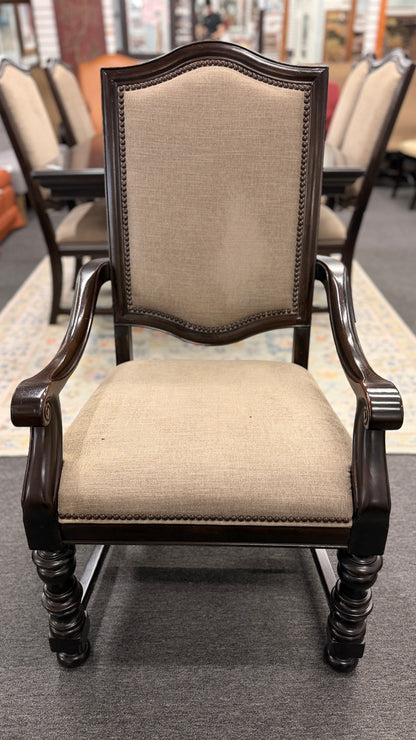 A traditional 7-piece dining set featuring a large rectangular wooden table, two high-back host armchairs, and four matching side chairs with fabric upholstery.