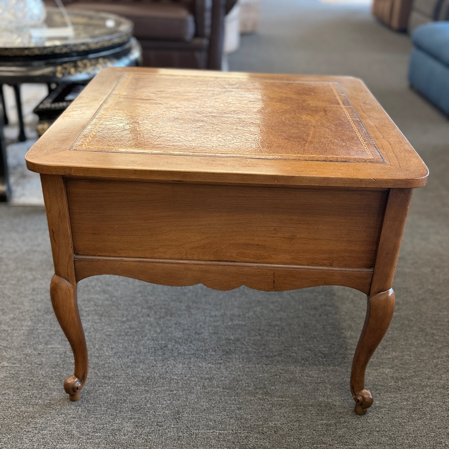 A square wooden end table featuring decorative gold inlay, two stacked drawers with ornate ring pulls, and cabriole legs.