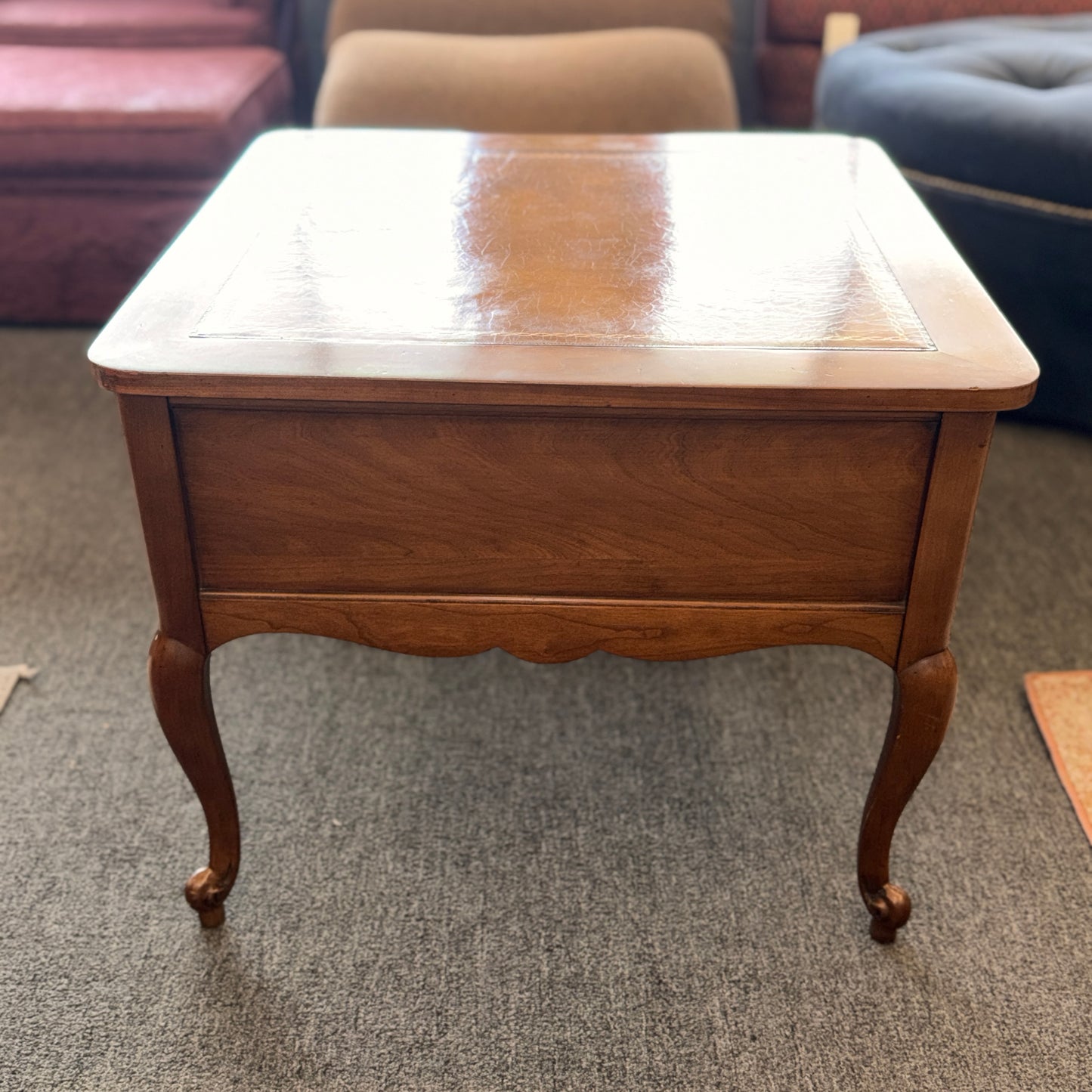 A square wooden end table featuring decorative gold inlay, two stacked drawers with ornate ring pulls, and cabriole legs.