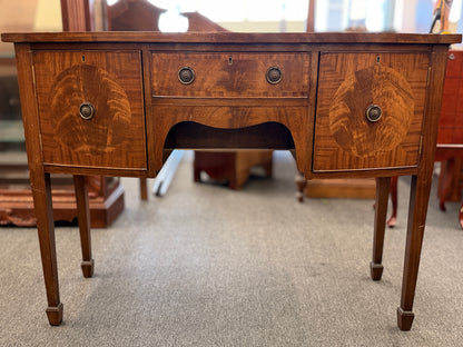 Traditional wood server featuring three front storage compartments with brass ring pulls, a scalloped bottom edge, and distinctive circular wood grain side panels.
