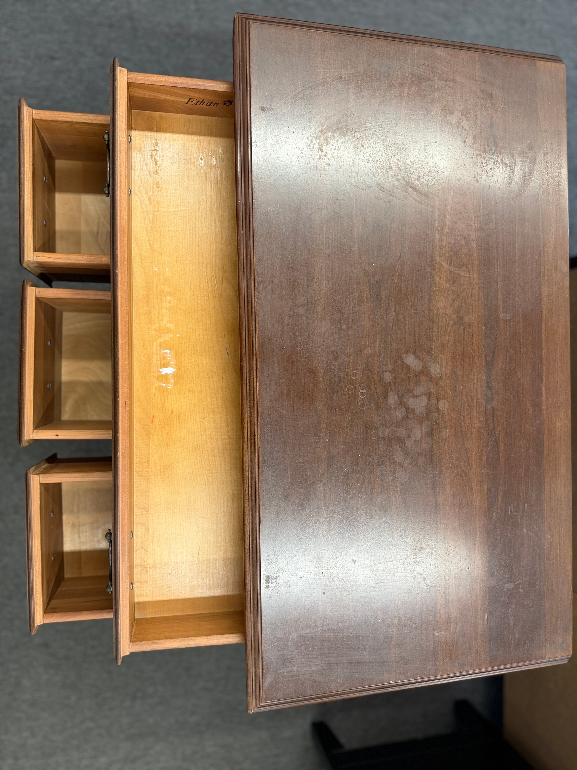 A traditional wooden lowboy accent dresser featuring four drawers with brass batwing drop pulls, a scalloped apron, and cabriole legs.