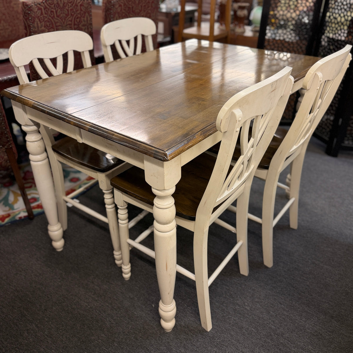 Two-tone counter-height dining set including a rectangular wood-top table with cream-painted turned legs and four matching open-back stools in excellent condition.