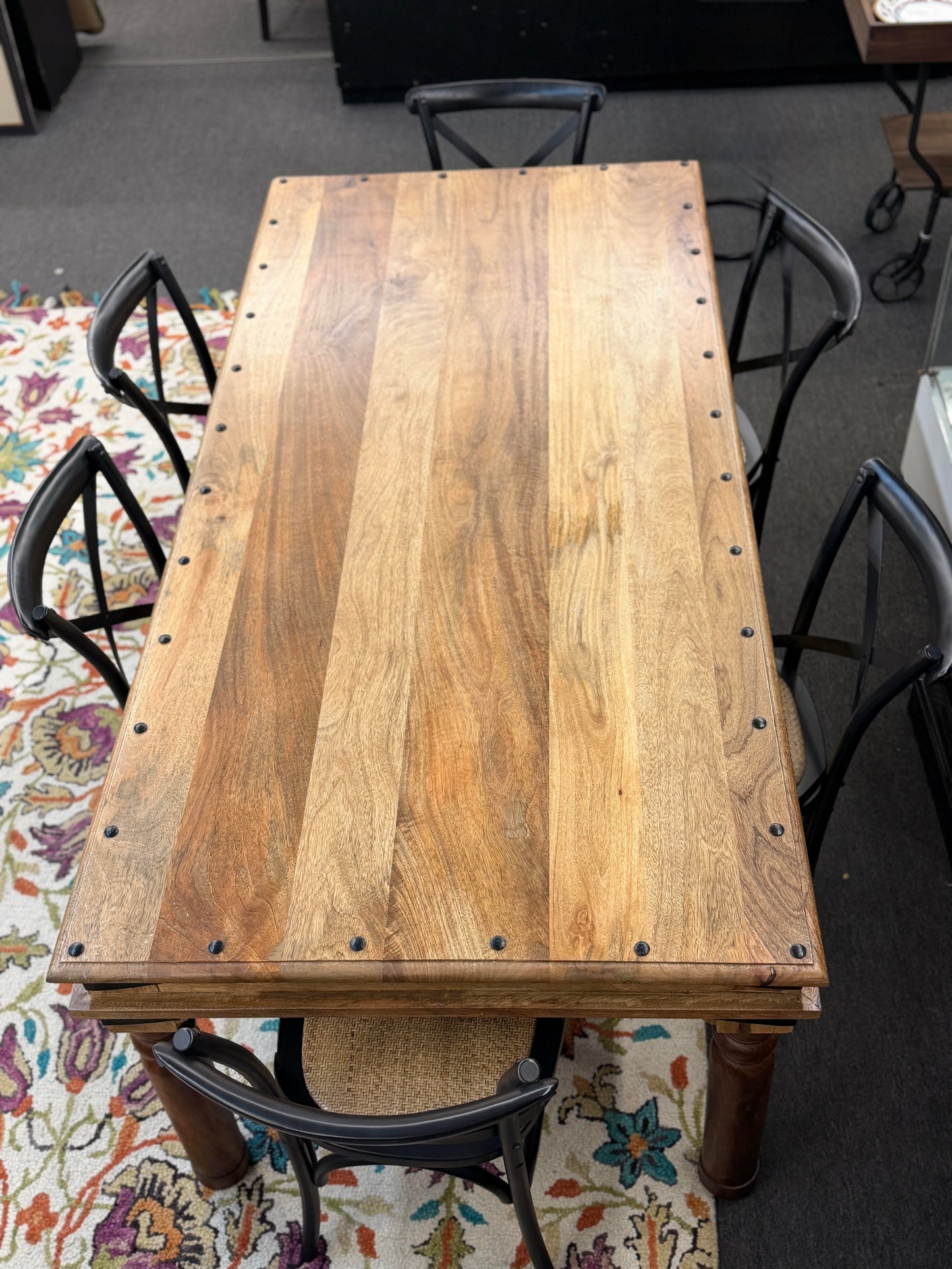 Wooden table with metal legs on a patterned rug