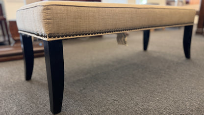 A 52-inch wide upholstered bedroom bench featuring a cushioned fabric top supported by a sturdy wooden frame.