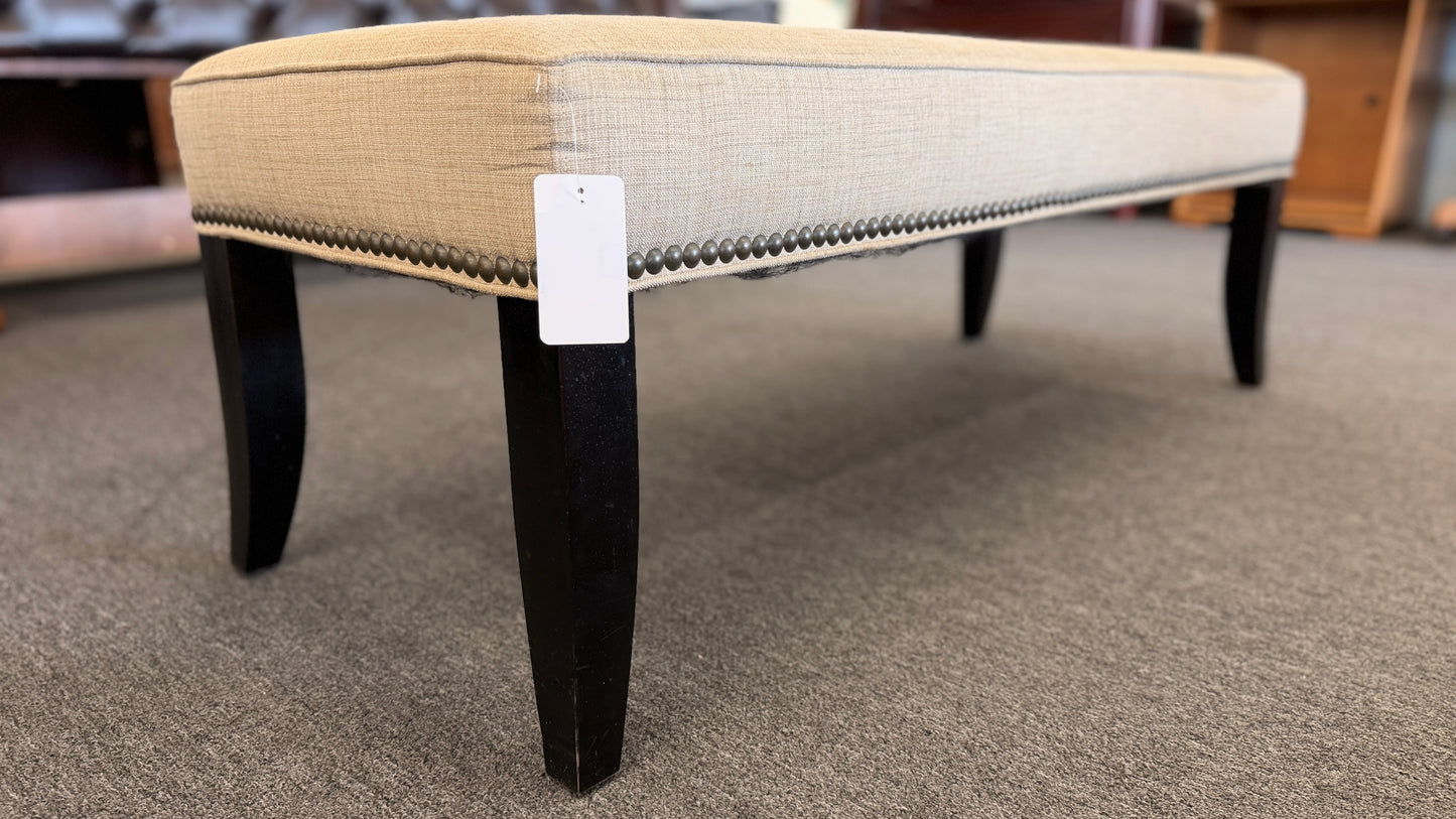 A 52-inch wide upholstered bedroom bench featuring a cushioned fabric top supported by a sturdy wooden frame.