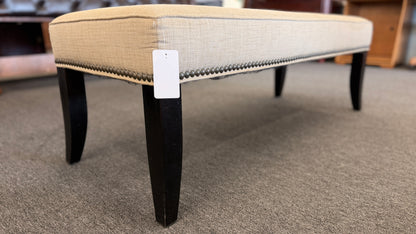 A 52-inch wide upholstered bedroom bench featuring a cushioned fabric top supported by a sturdy wooden frame.
